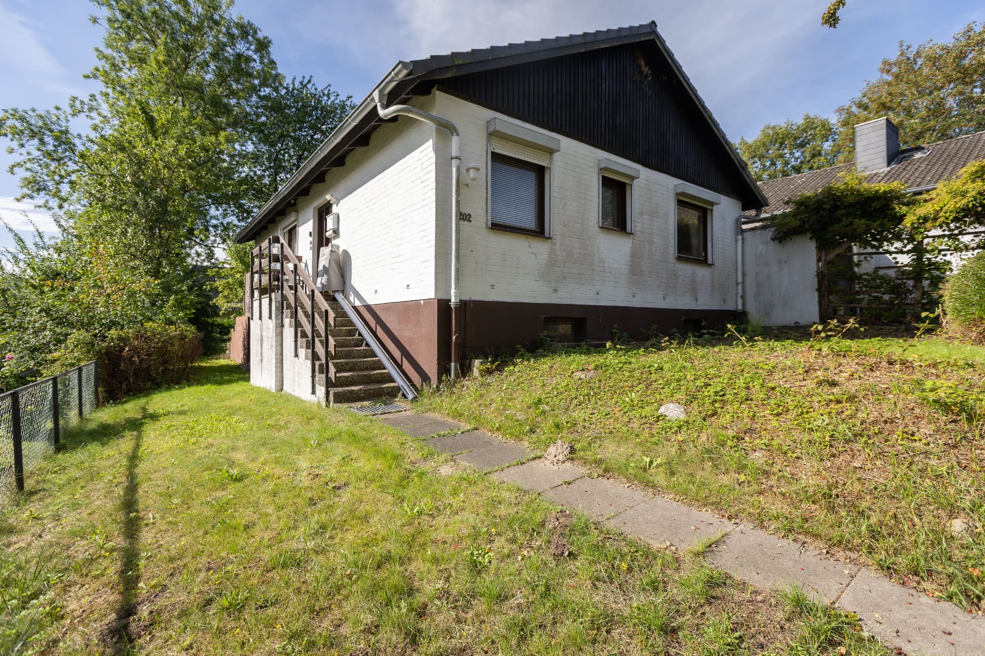 Einfamilienhaus von 1972 mit Außentreppe und Rasenfläche in Hamburg-Bergedorf
